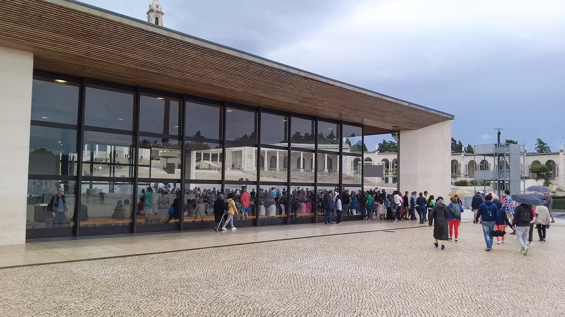 Visitors gather at the modern entrance of the Sanctuary of Fátima, a popular stop on the customizable Porto to Lisbon tour.