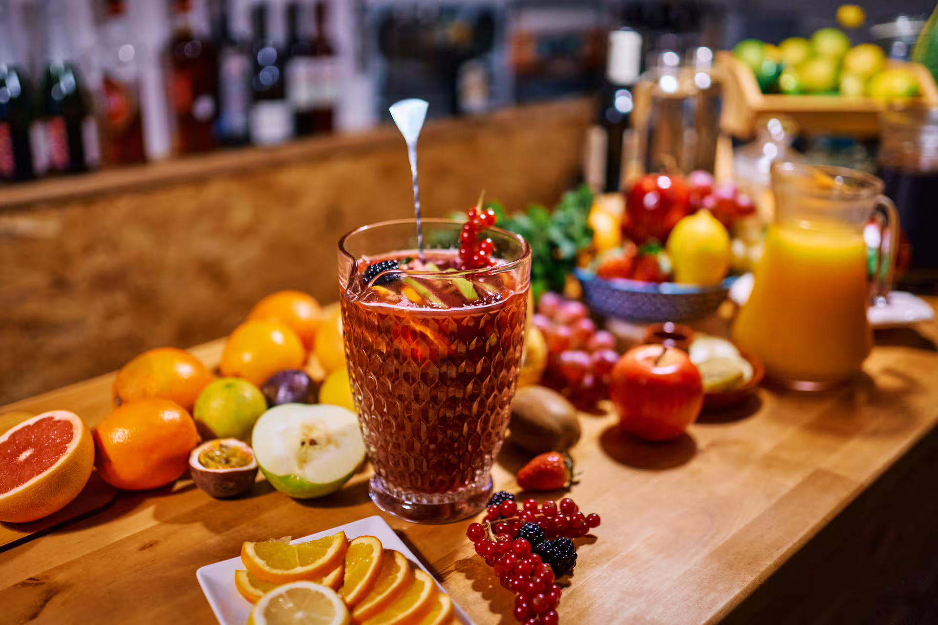 Vibrant sangria pitcher surrounded by fresh fruits and citrus slices, part of the Ultimate Paella Cooking Class Experience.