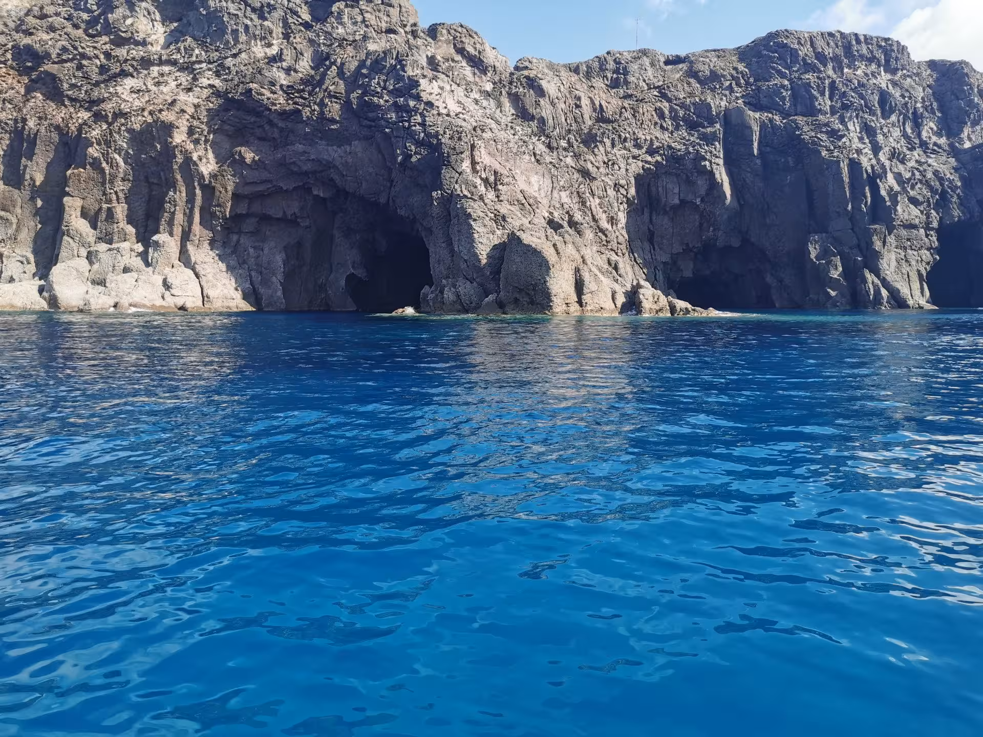 Discover hidden sea caves along the rugged cliffs during the Sant'Antioco to Carloforte RIB adventure.