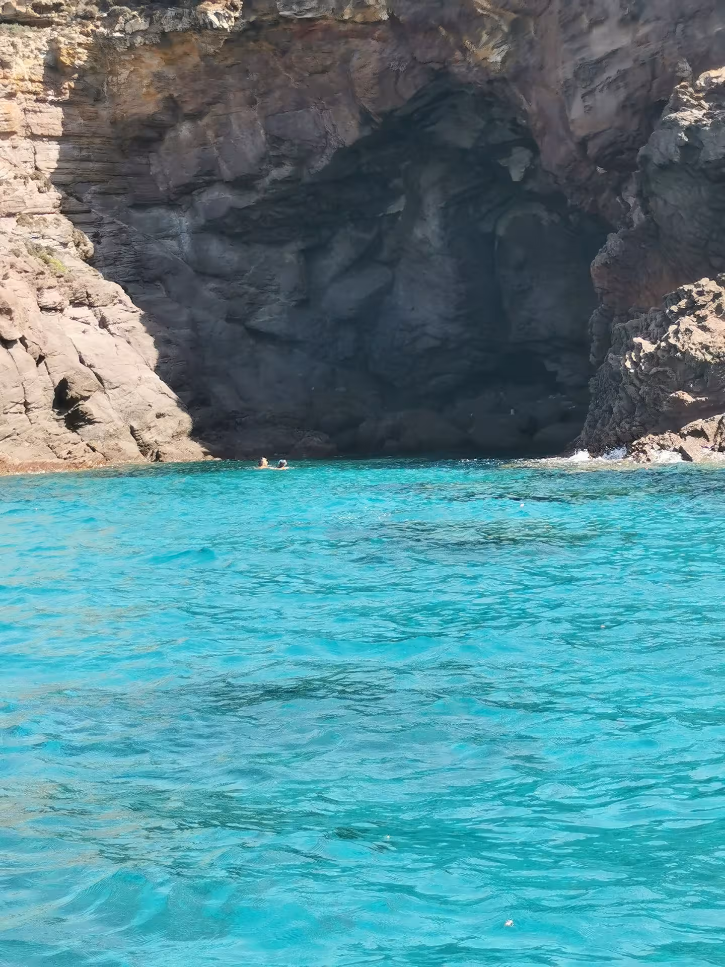 Swim in crystal-clear waters near dramatic cliffs on the Sant'Antioco to Carloforte RIB tour experience.