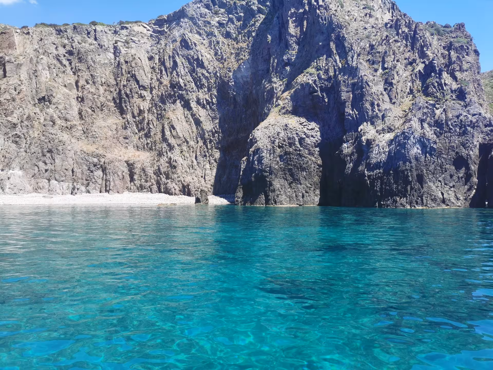 Explore the stunning rocky cliffs of Sant'Antioco's coastline on a 4-hour RIB tour with crystal-clear waters.