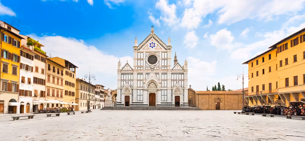 Historic Santa Croce Basilica in Florence's vibrant square, a highlight of guided E-bike tours.