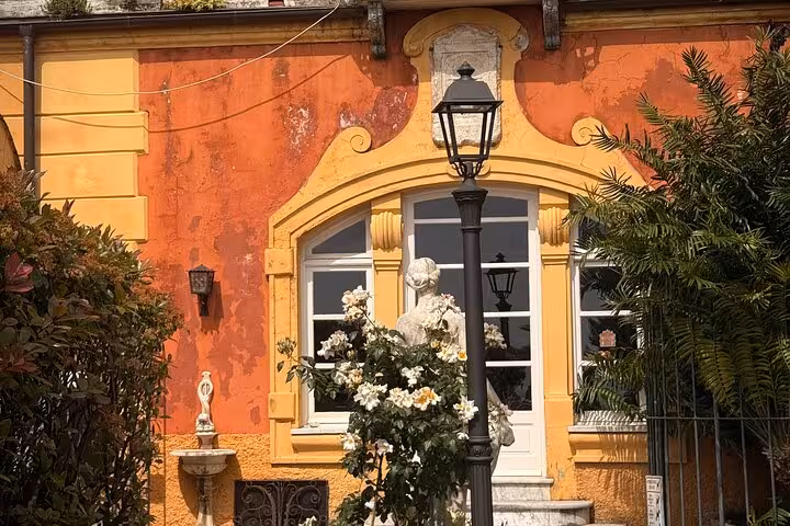 Charming Ligurian architecture with vibrant orange facade in Santa Margherita food tour.