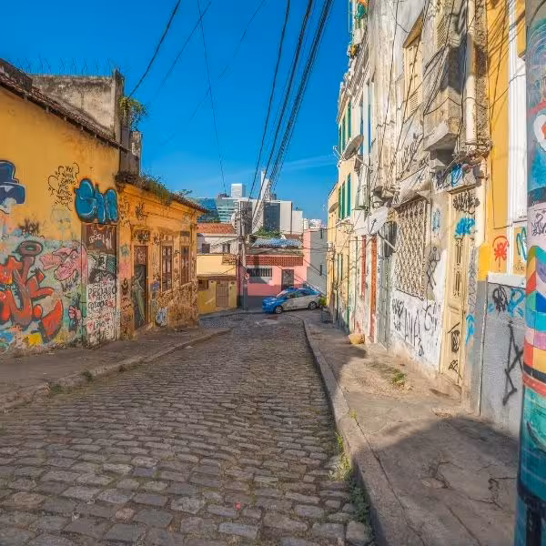 Vibrant cobblestone street in Santa Teresa adorned with colorful graffiti, perfect for cultural exploration in Rio.