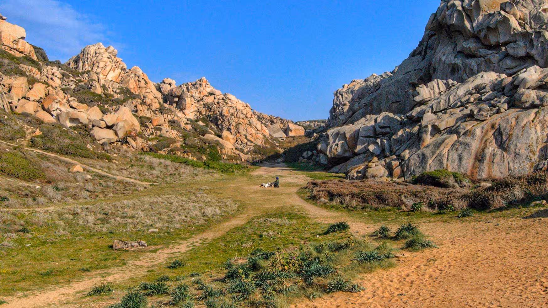 Serene valley surrounded by dramatic rock formations in Valle della Luna, perfect for hiking in Santa Teresa Gallura.