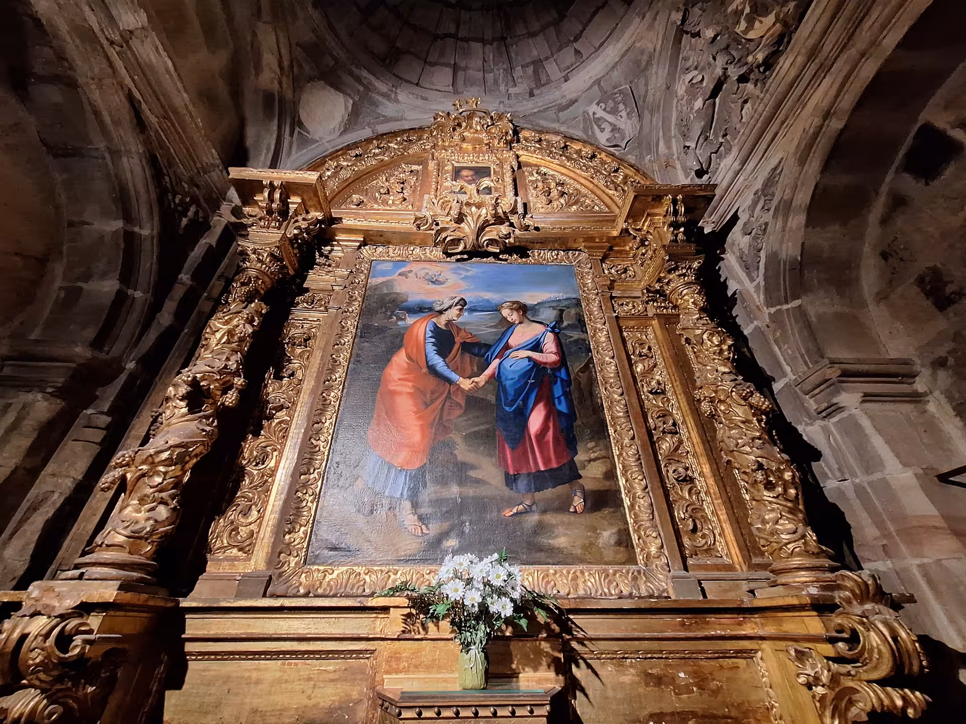 Ornate religious painting framed in gold inside Santander Cathedral, highlighting cultural richness on a guided visit.