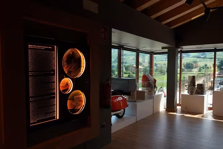 Interior view of a museum in Santander with illuminated displays and scenic countryside views, perfect for cultural exploration.