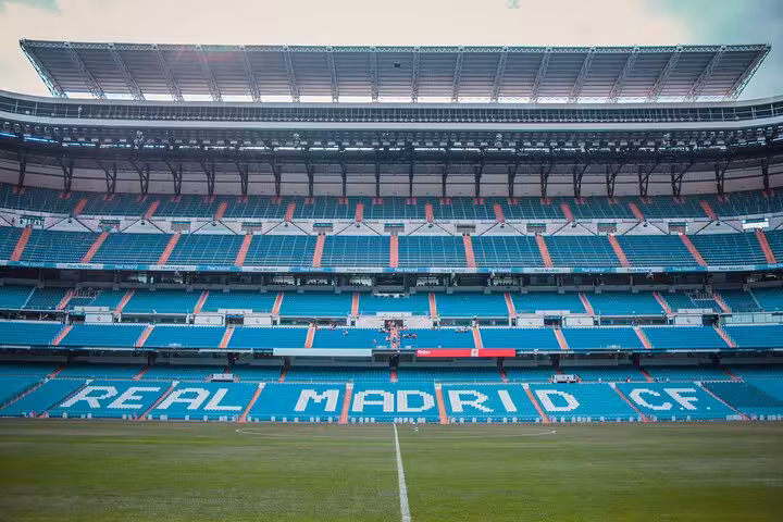 Santiago Bernabéu seating with Real Madrid CF lettering, part of Madrid matchday experience with local