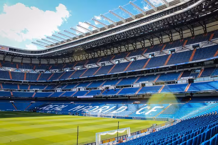 Sunlit Santiago Bernabéu stadium bowl and pitch, Madrid Real Madrid matchday experience tour with local