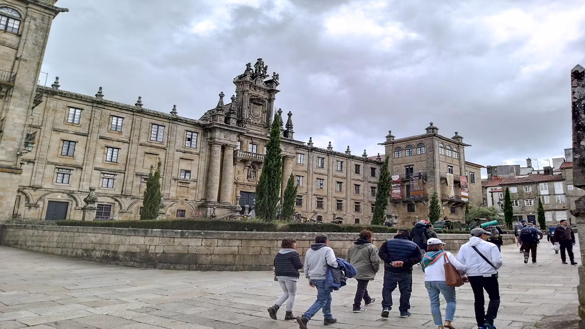 Tourists explore the historic architecture of Santiago de Compostela on a private guided tour, highlighting its iconic cathedral.