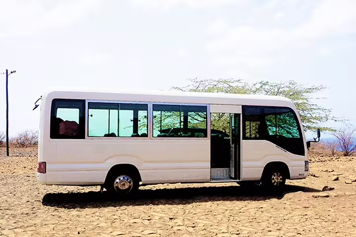 White minibus for Santiago Island 1-way private airport transfer to Tarrafal, Cape Verde, parked roadside