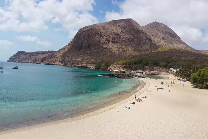 Tarrafal Beach on Santiago Island with turquoise bay and mountains, scenic stop after private airport transfer