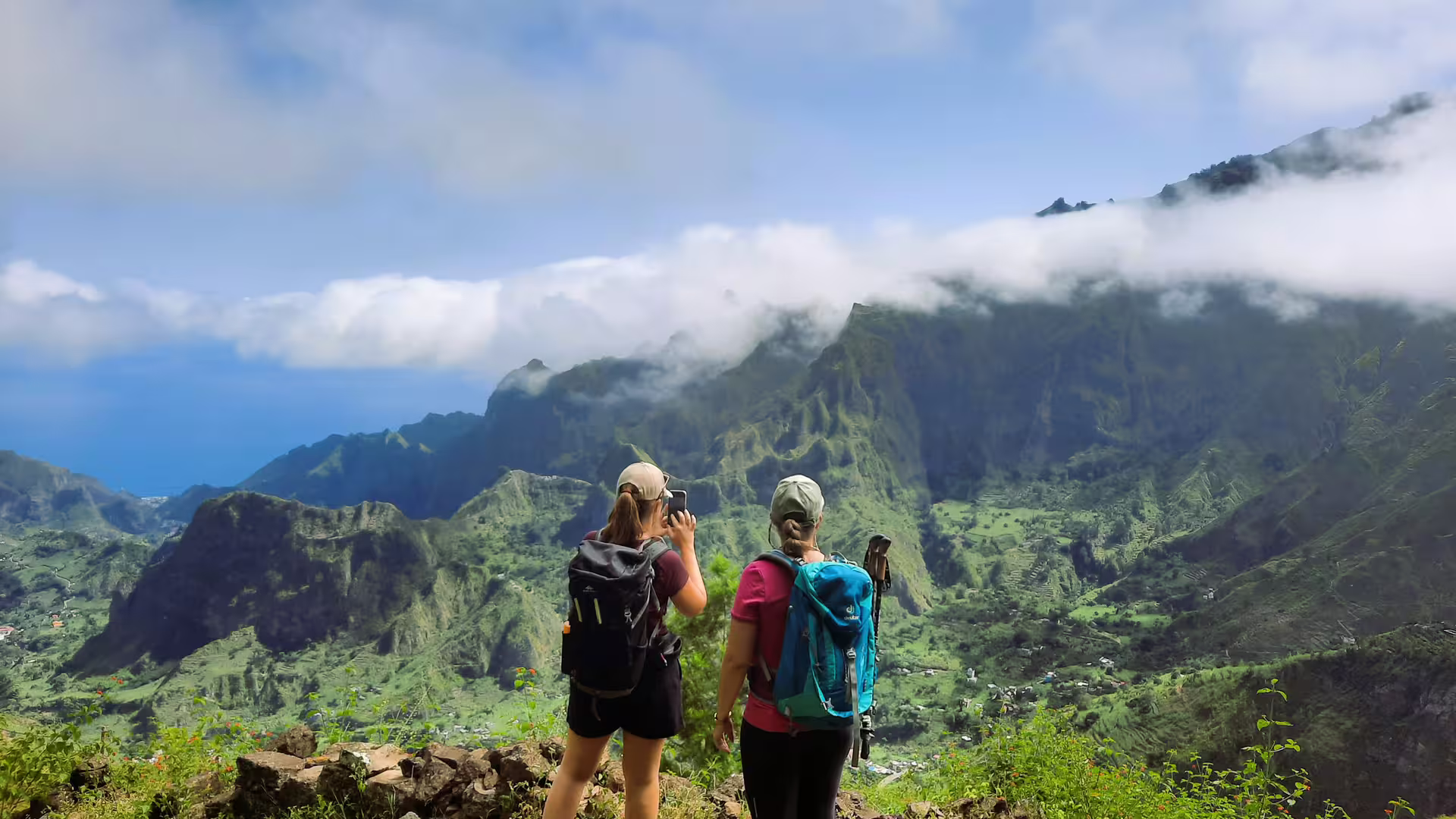 Hikers overlooking the stunning Cova de Paúl crater in Santo Antão, capturing the scenic volcanic landscape.