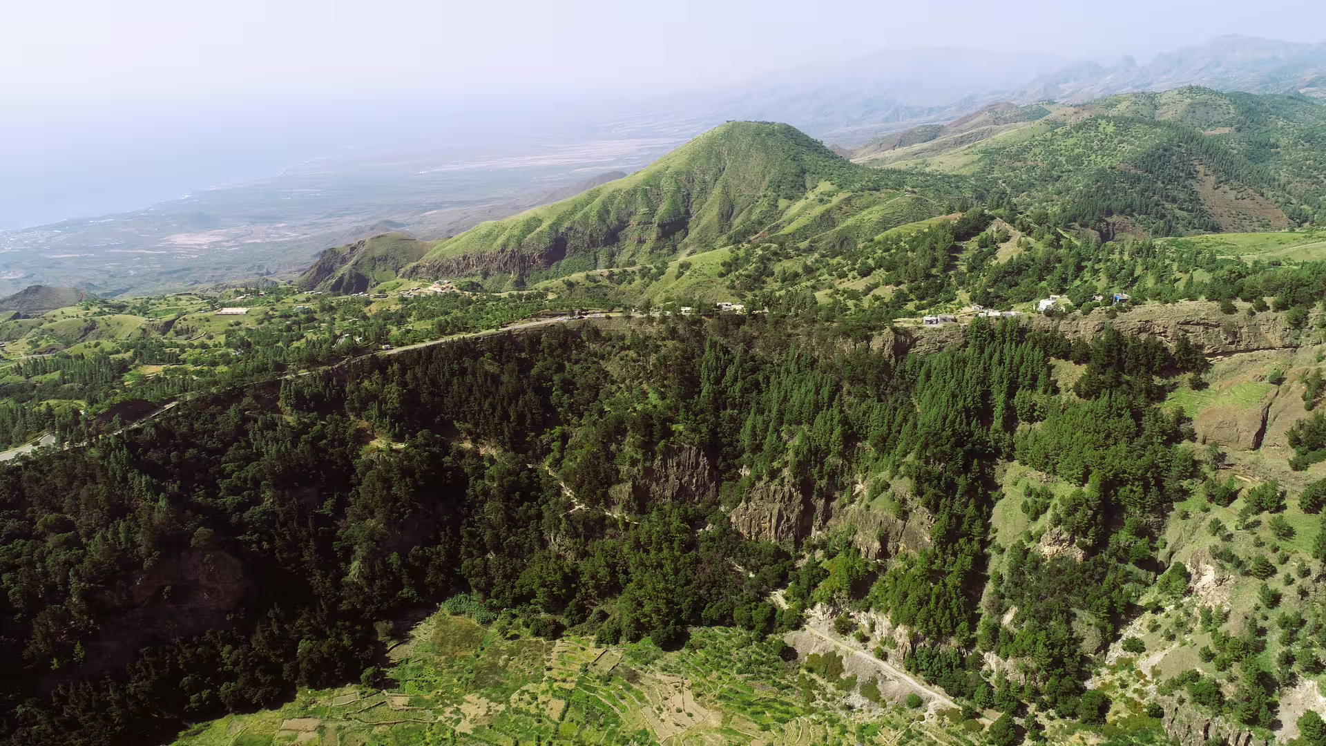 Panoramic view of green mountains and valleys in Santo Antão, ideal for nature lovers exploring Cova de Paúl.