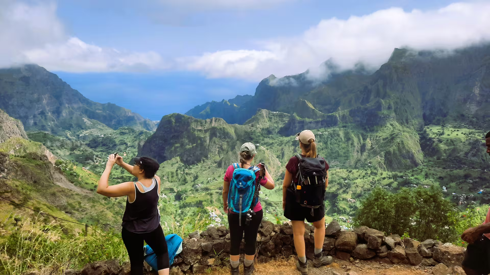Group of trekkers capturing the stunning landscape of Ribeira de Paúl, with expansive mountain views in Santo Antão.