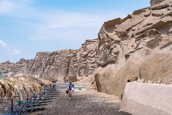 Santorini black sand beach walk beneath volcanic cliffs, scenic stop on a private 2-hour island sightseeing tour