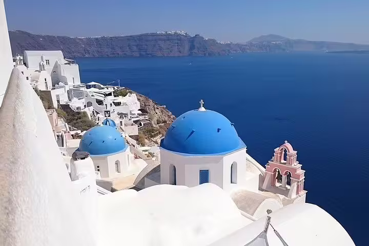Scenic view of iconic blue-domed churches overlooking the Aegean Sea in Santorini, perfect for a private full-day sightseeing tour.
