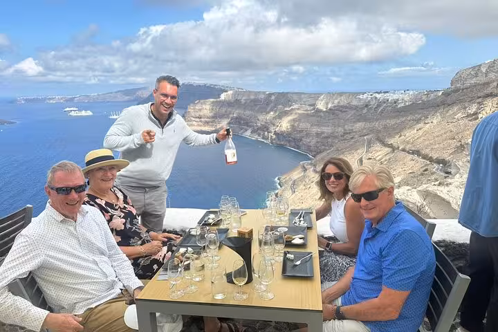 Guests enjoy Santorini caldera-view lunch and wine tasting on an 8-hour Island of Thera day tour