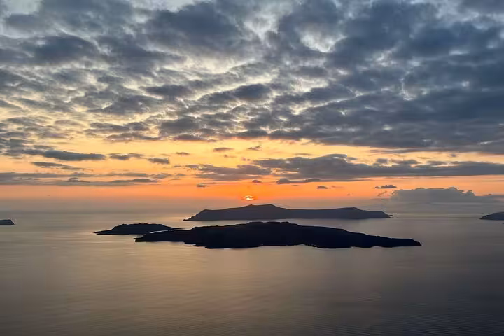 Santorini caldera sunset view over volcanic islands, scenic stop on private honeymoon romantic sunset wine tour