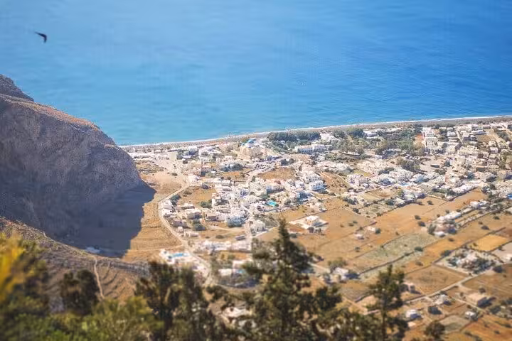 Panoramic view of Santorini coastline and villages from a viewpoint on a private day trip from Crete
