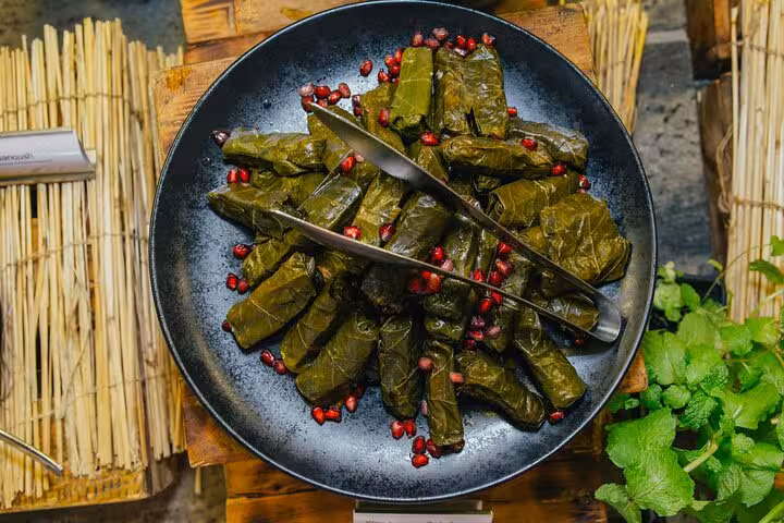 Greek dolmades in vine leaves with pomegranate seeds, a classic dish from Santorini cooking class