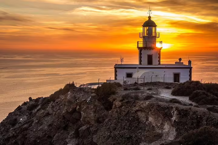 Scenic view of Santorini lighthouse at sunset during a private full-day sightseeing tour with a local guide in Greece.