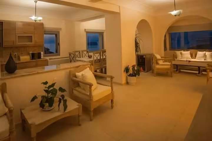 Spacious Santorini luxury villa interior with kitchen and lounge, day getaway package with private transport