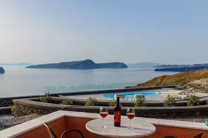Santorini luxury villa stay with private pool and caldera view, wine on terrace, includes round-trip transport