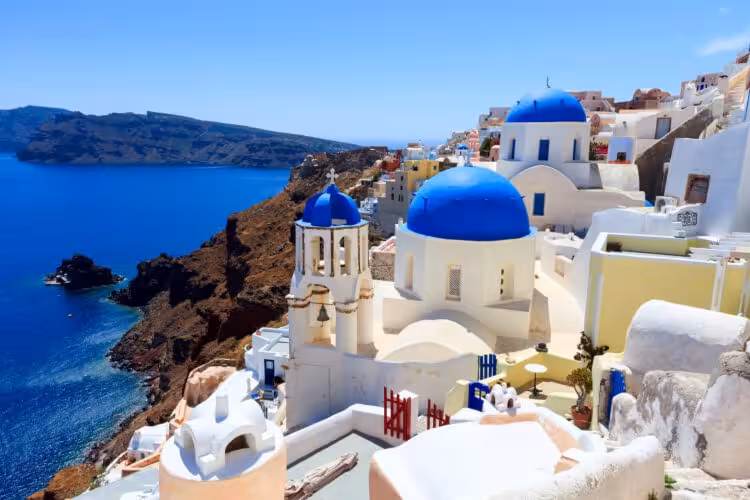Oia blue-domed churches and Santorini caldera view on a private highlights tour and shore excursion