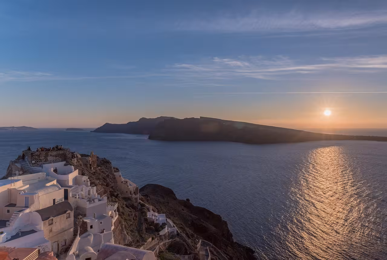 Santorini sunset view from Oia cliffs over the caldera and Aegean Sea, a must-see highlight tour stop