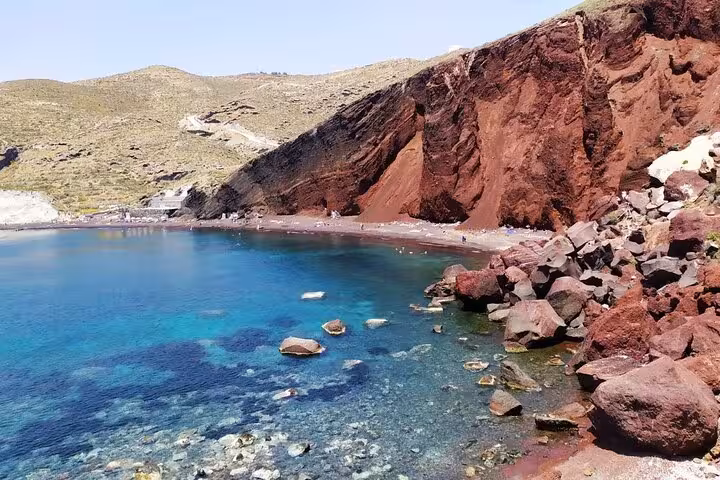 Santorini Red Beach with volcanic cliffs and clear blue water featured on private sightseeing tour from Athens