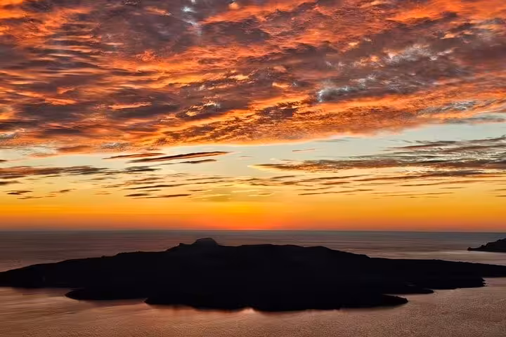 Santorini caldera sunset view over Aegean Sea, perfect backdrop for wine tour with tapas at two wineries