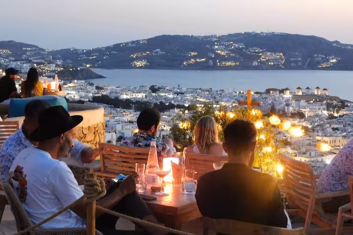 Santorini sunset dining terrace overlooking the caldera on a 5-day private Athens to Mykonos tour