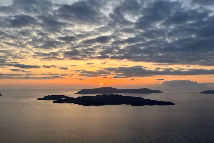 Santorini caldera sunset over volcanic islands, scenic finale on private sunset wine tour with 3 wineries and tapas