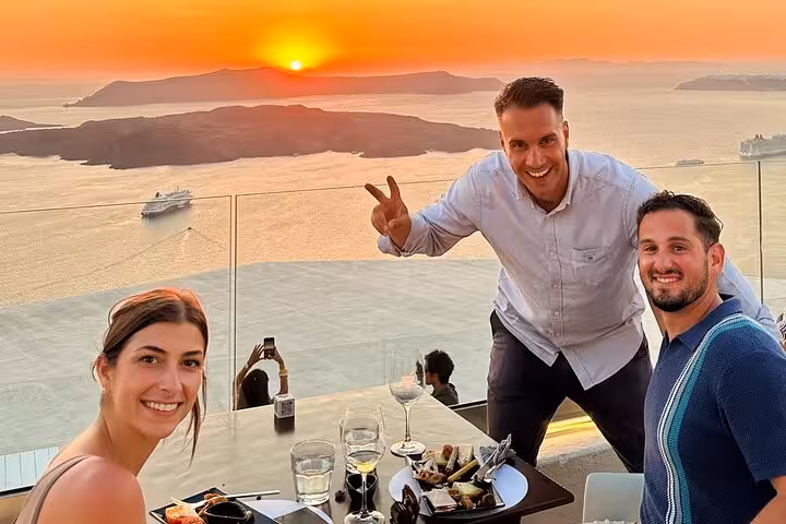 Couple enjoying Santorini caldera sunset wine tour with tapas pairing, two winery tastings and sea views
