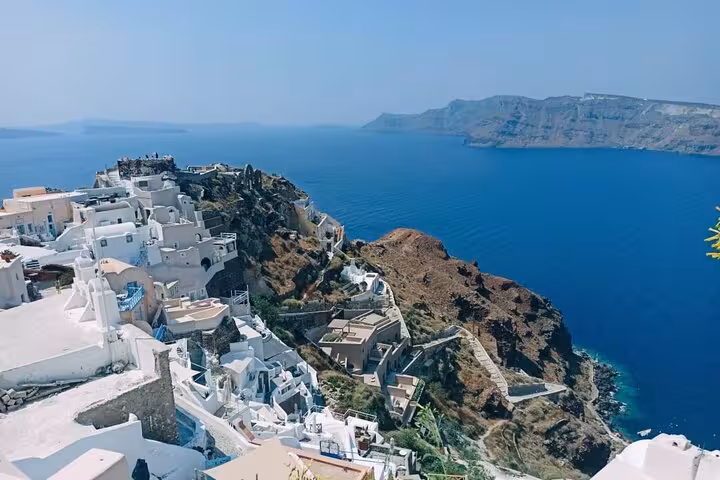 Whitewashed cliffside village in Santorini with caldera views, highlight of private day trip from Crete
