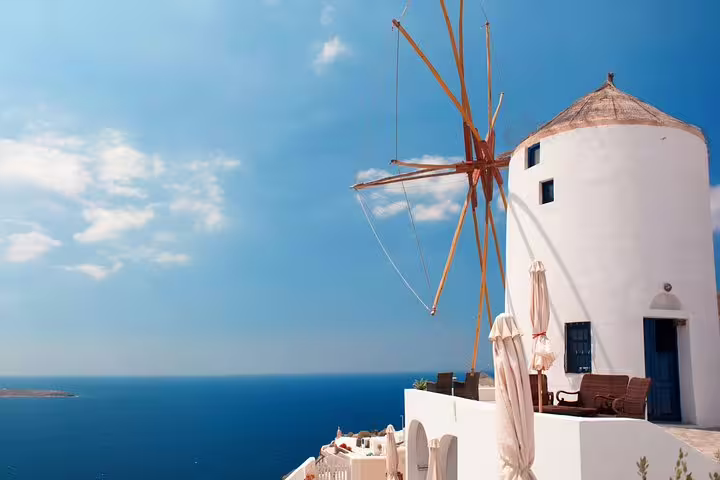 Iconic Santorini windmill overlooking the Aegean Sea, part of the Santorini Highlights 3-day private tour from Athens