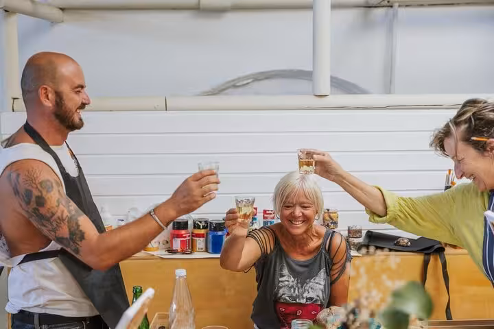 Guests toast with Santorini wine during a fun paint and sip class at the Santorini wine and paint tour