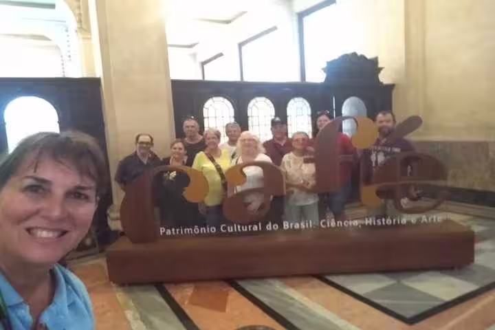 Tourists posing at the Santos Coffee Museum, a key stop on the 7-hour shared group tour in Brazil.