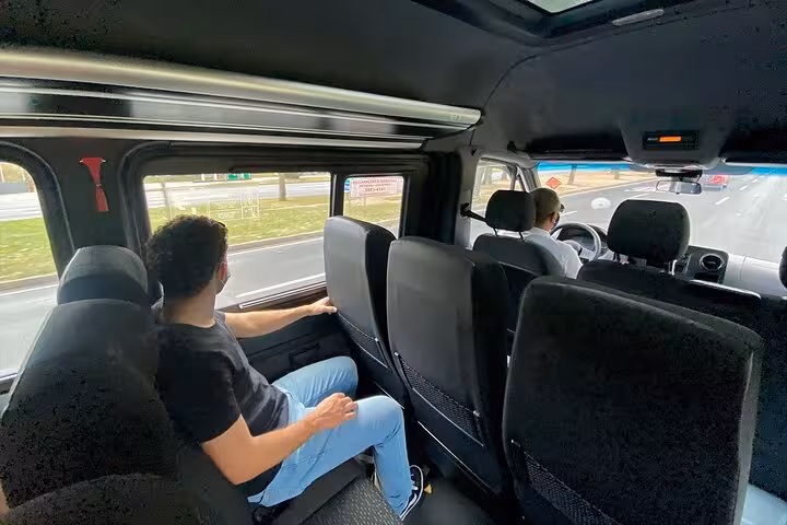 Passenger enjoying scenic view from shuttle during São Paulo to Paraty transfer, showcasing comfortable travel.