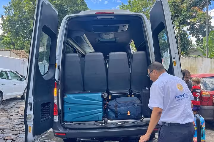 Luggage being loaded into Paraty Tours shuttle van in São Paulo for shared transfer to Paraty, showcasing convenient travel.