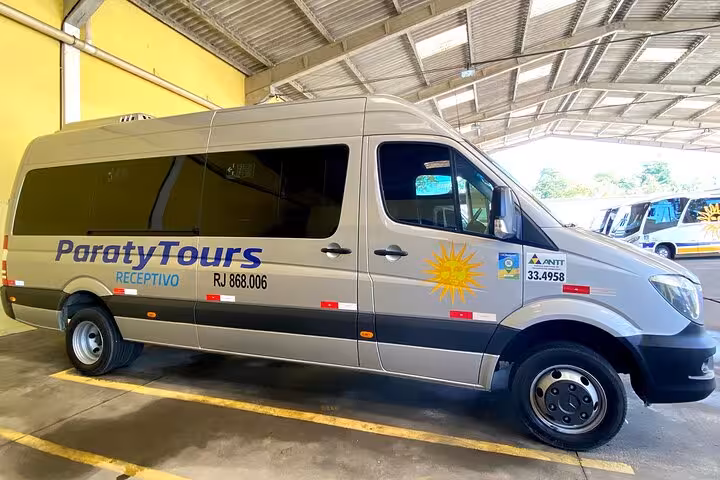 Paraty Tours shuttle van in a garage ready for São Paulo to Paraty transfer, showcasing reliable and comfortable travel.