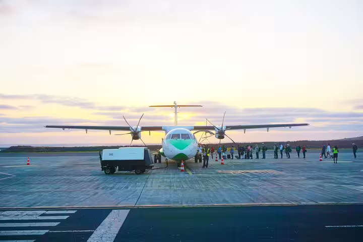 Plane on São Vicente airport runway at sunset, ideal for private airport transfer to Lazareto accommodation