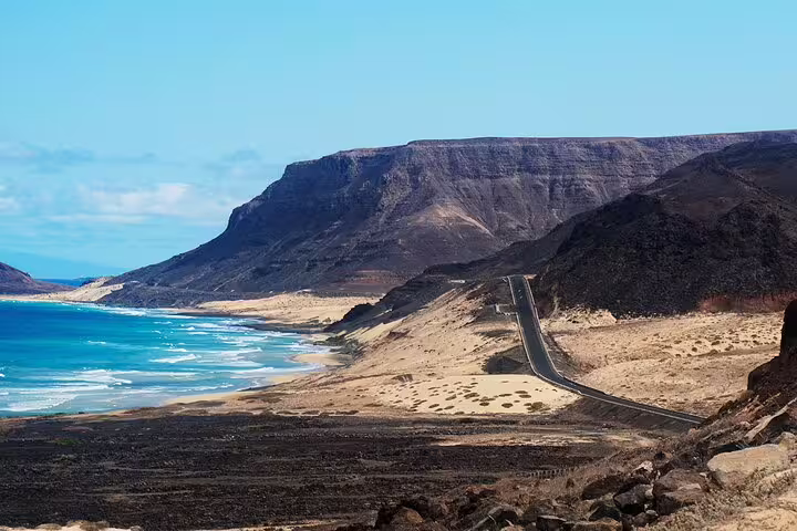 Scenic coastal road along São Vicente Island's rugged cliffs and turquoise waters, perfect for a picturesque drive.