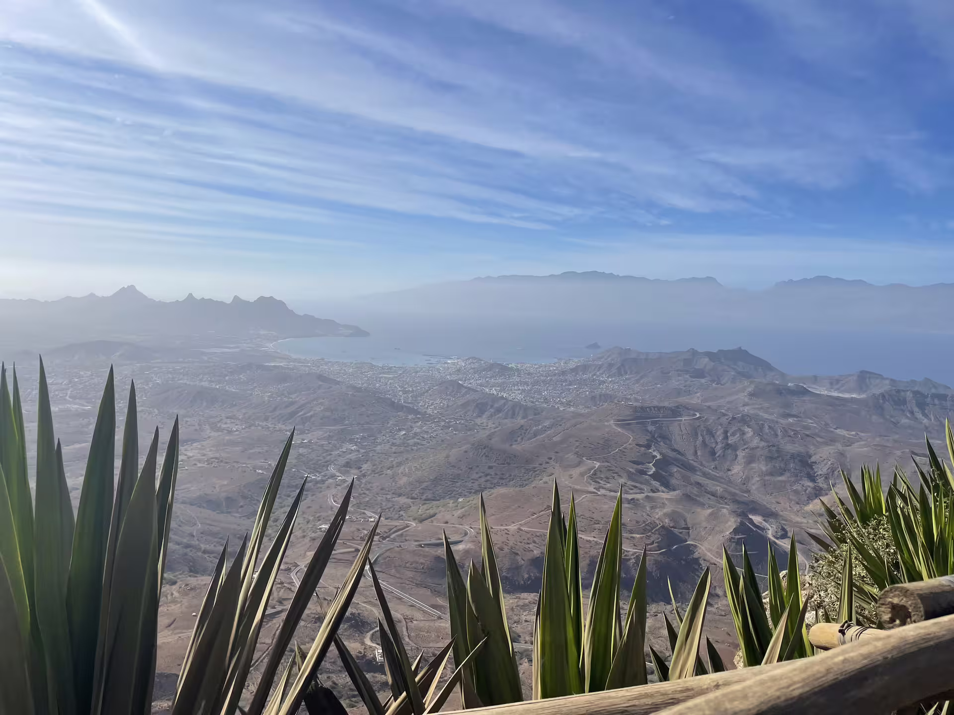 Breathtaking view of São Vicente's rugged landscape and Mindelo's coastline on a clear day, perfect for a half-day excursion.