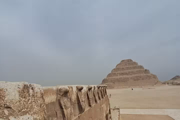 Saqqara Step Pyramid view with carved stone wall at Memphis necropolis, part of Saqqara & Giza tour