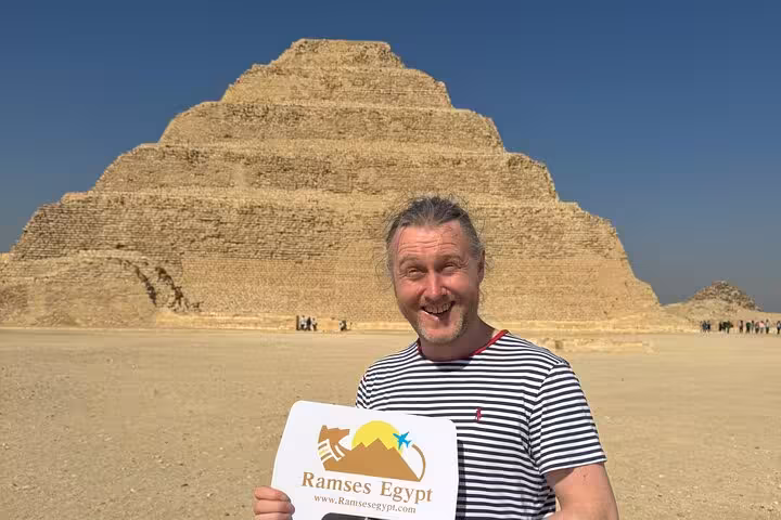 Visitor posing by Saqqara Step Pyramid on private Saqqara Memphis and Dahshur Red Pyramid day tour