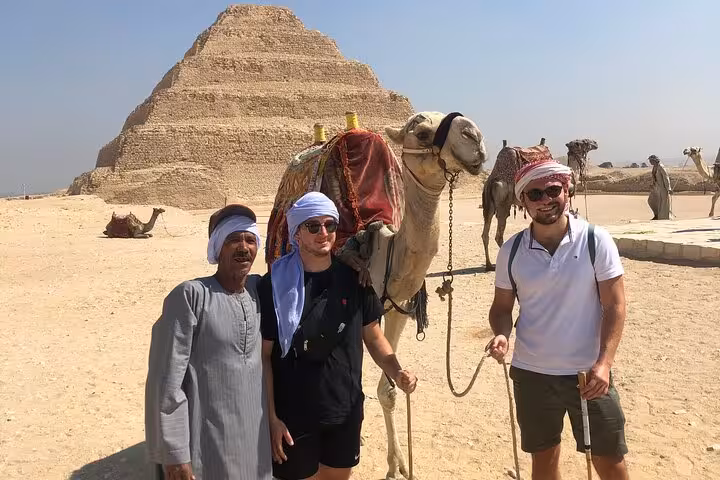 Tourists with camel at Saqqara Step Pyramid on Saqqara, Dahshur and Memphis day tour with lunch