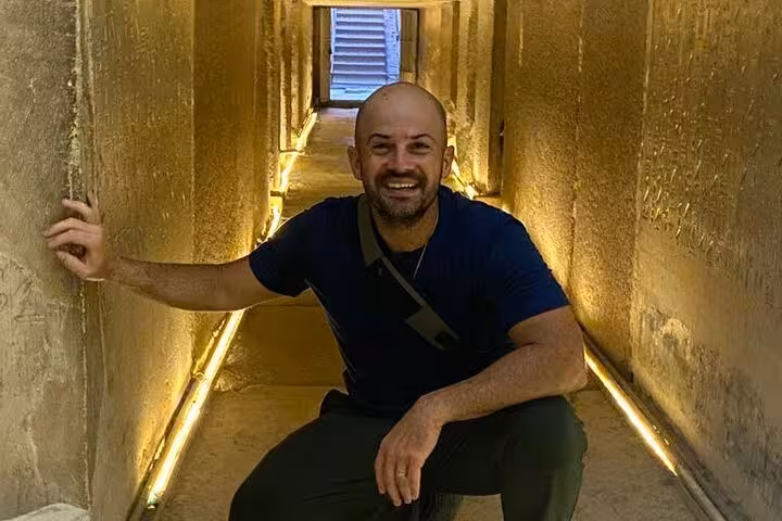 Traveler inside Saqqara tomb corridor on private tour to Giza Pyramids, Memphis and Saqqara necropolis