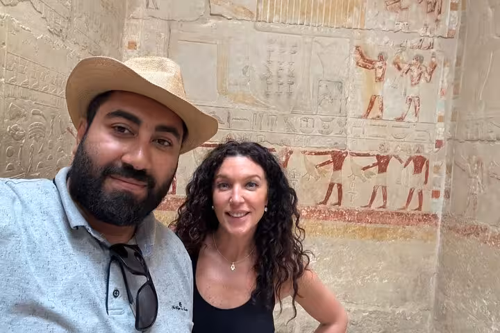 Private Saqqara tour from Cairo with Egyptologist guide and travelers inside tomb with ancient wall art